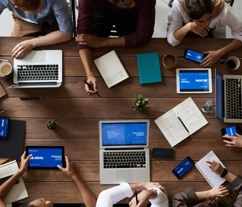 top view photo of people near wooden table 3183150